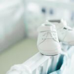 Baby shoes on baby bed